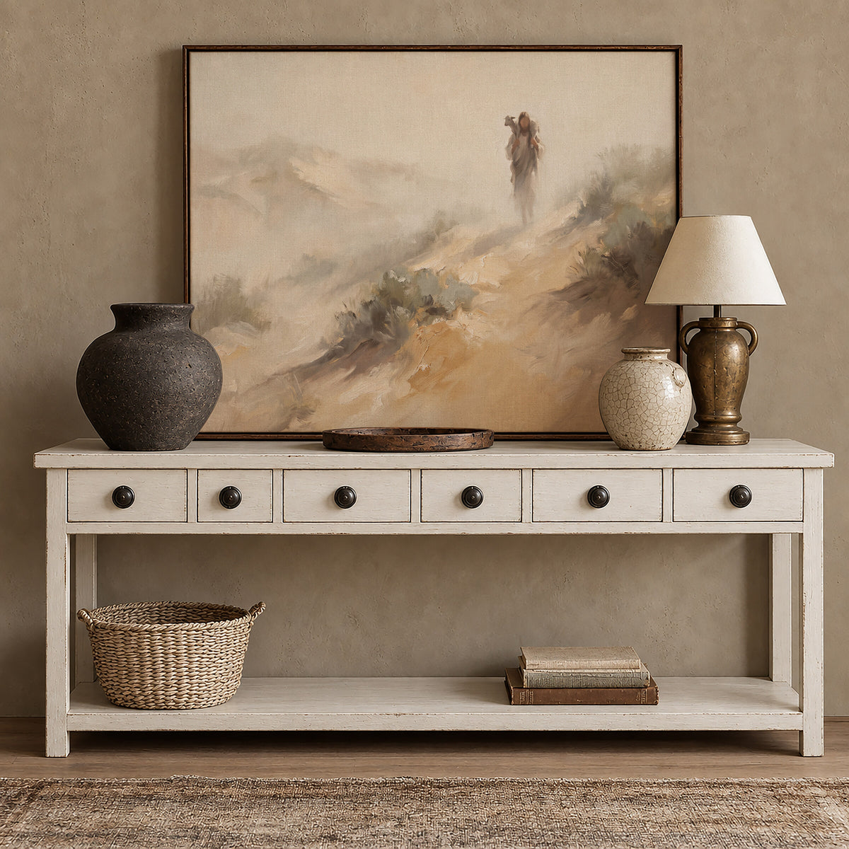 Carrying the Lamb Down the Dune framed wall art above a white console with brass accents