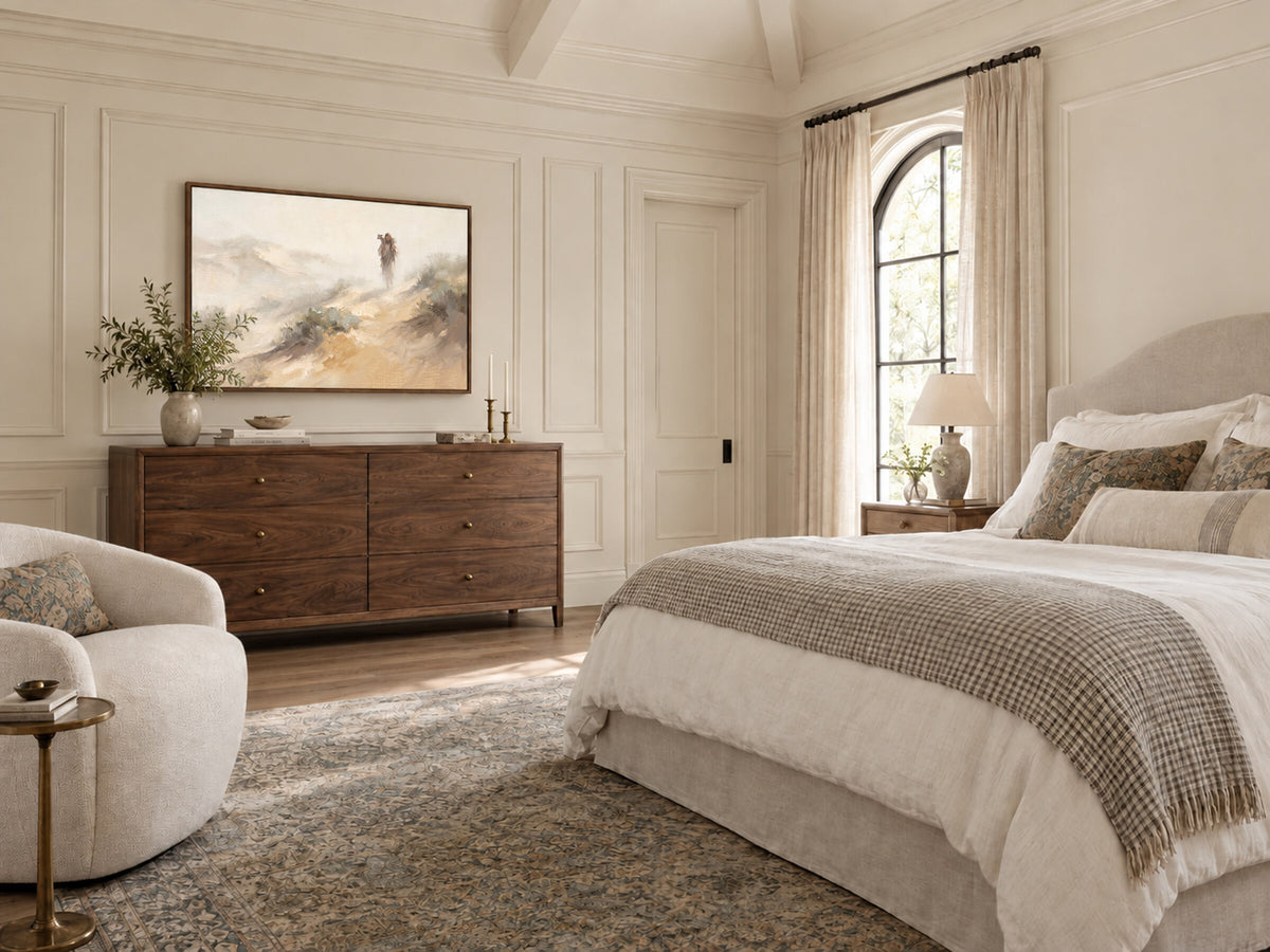 Carrying the Lamb Down the Dune framed wall art in a bedroom above a walnut dresser