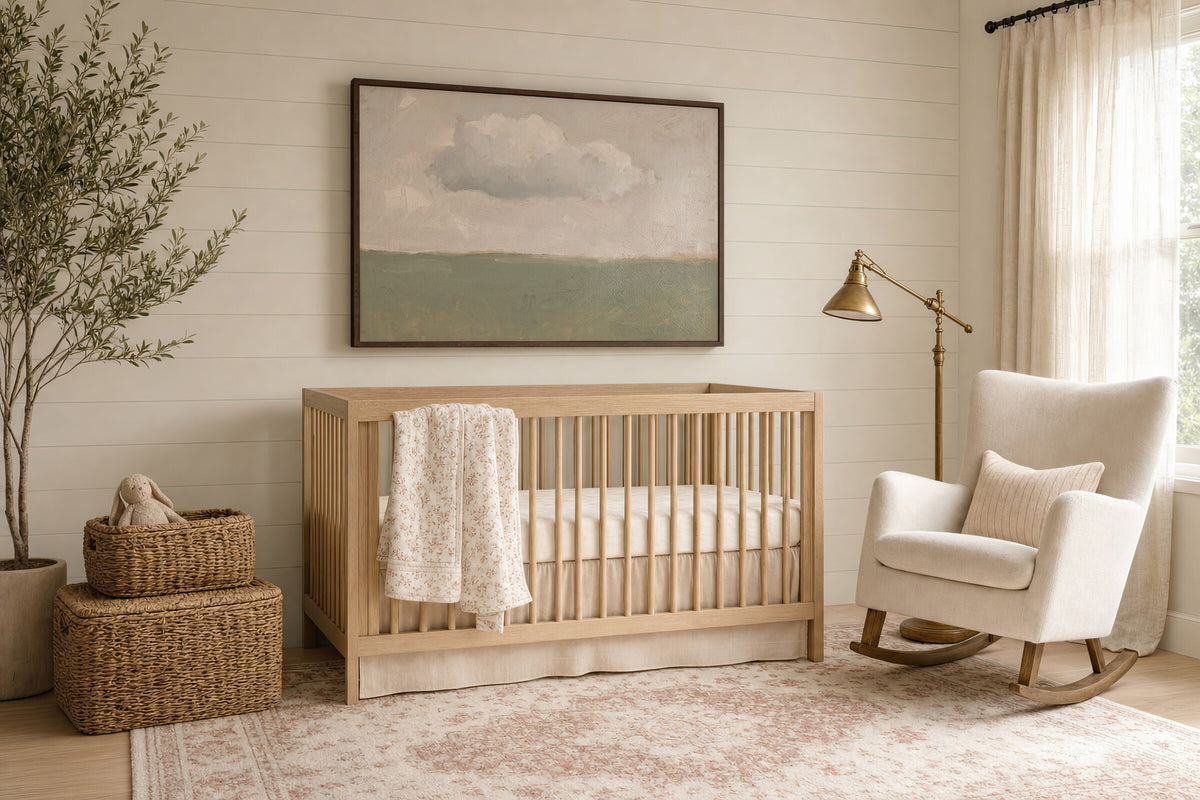 One Cloud Over Sage Field framed wall art in a soft nursery beside the crib