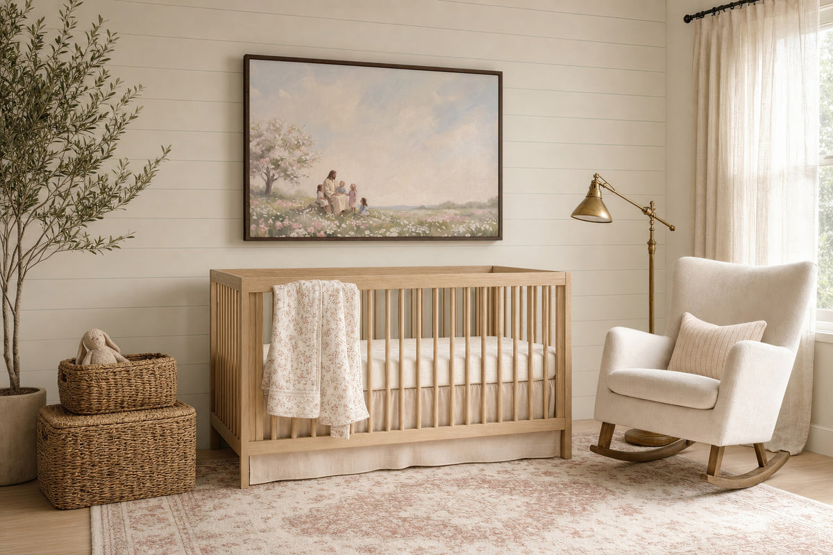 Children in the Blossom Meadow framed wall art in a soft nursery beside the crib